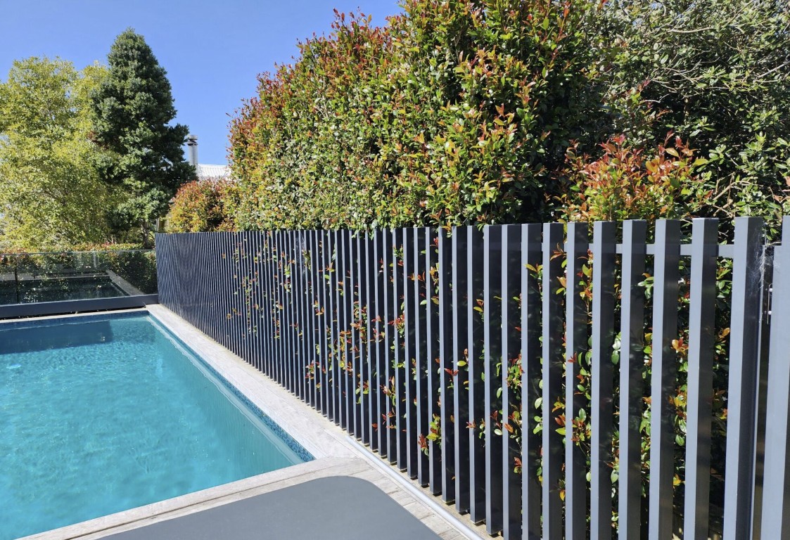 Black aluminum pool safety fence installation in Pike Road residential property