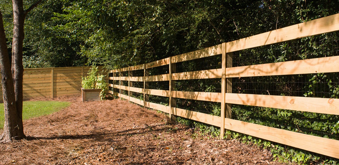 Natural wood horizontal rail fence installation in Pike Road, Alabama